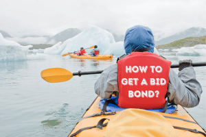 Kayaker paddling through icy waters in Alaska with 'How to Get a Bid Bond?' written on the back of their life jacket, symbolizing the process of obtaining bid bonds in Alaska.