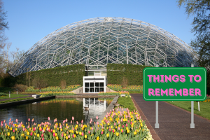 A picturesque image of a geodesic dome structure surrounded by tulips with a green sign that reads "Things to Remember", highlighting key points about bid bonds in Missouri.