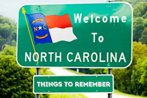 Welcome to North Carolina sign with additional 'Things to Remember' banner, symbolizing important considerations for bid bonds in the state.