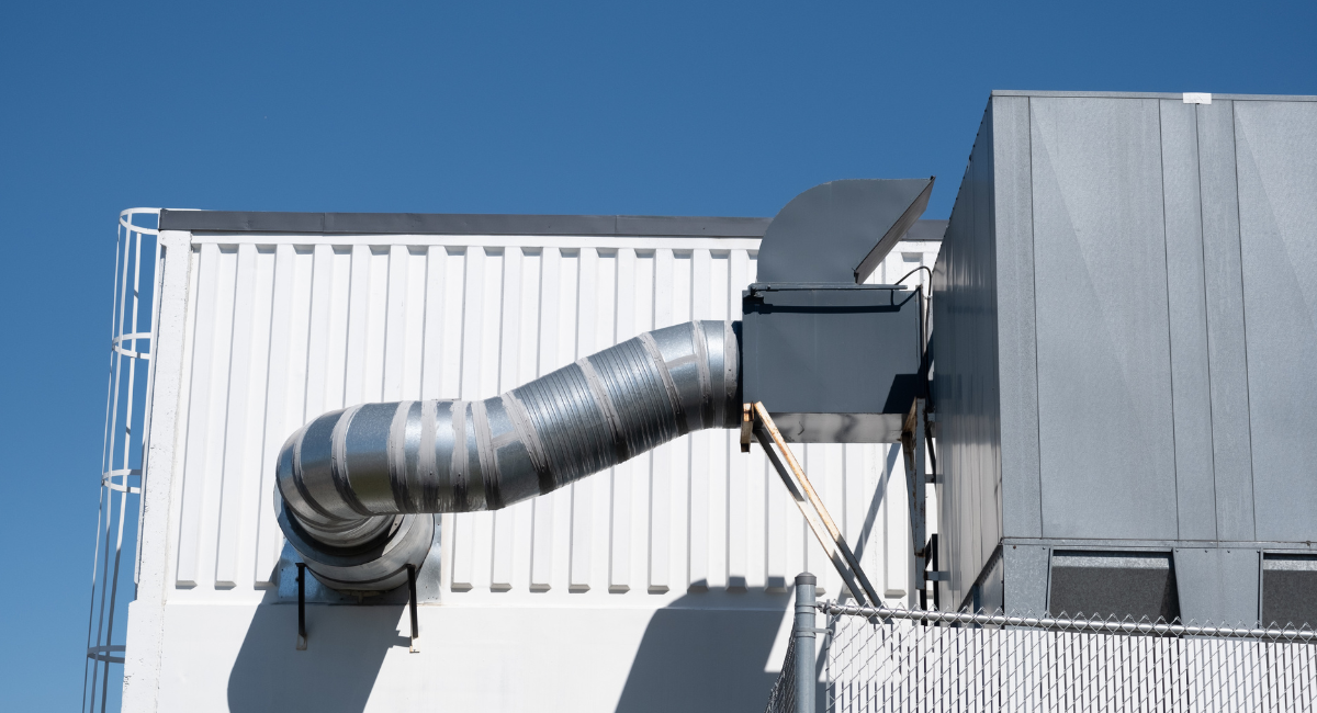 Industrial HVAC ductwork and ventilation system installed on a building exterior.