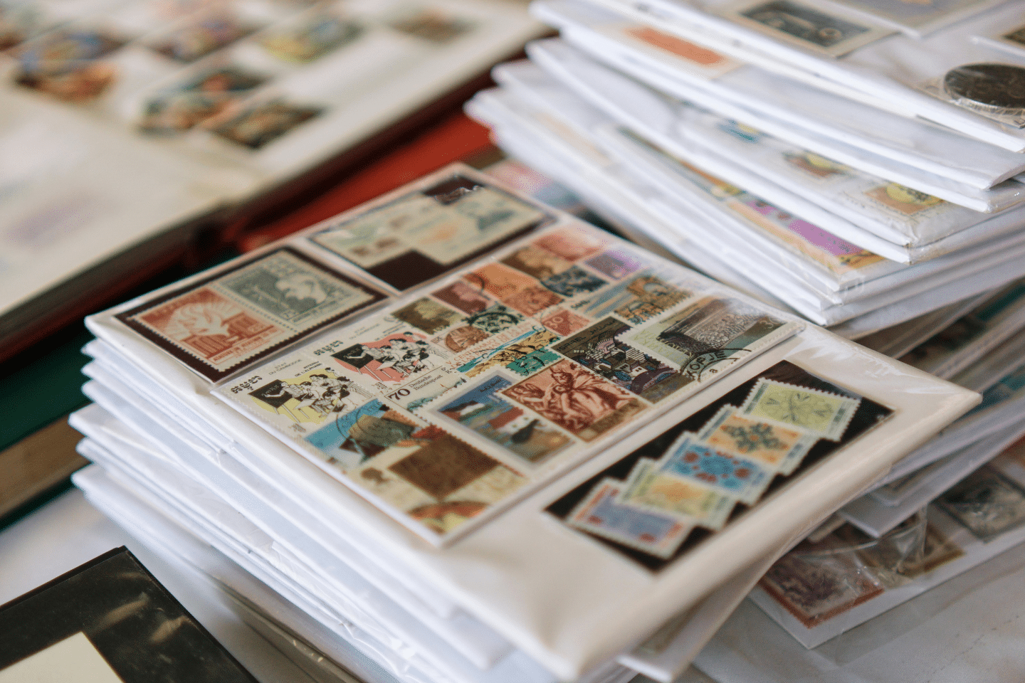 Stacks of stamp albums filled with international postage stamps in protective sleeves.