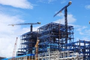 Construction Bond - The images shows a constructed building and a tower cranes.
