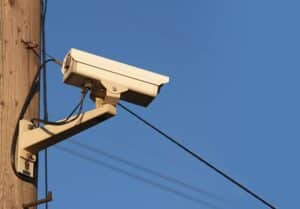 Attaching Equipment on Utility Poles with a background of blue sky.