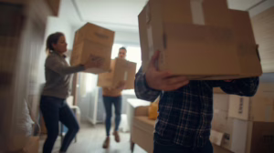 House moving crew lifting and transporting boxes safely as part of a bonded house moving operation in Haltom City, Texas.