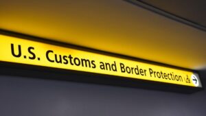 US Customs Sign - A US customs and border protection guide with a color yellow light.