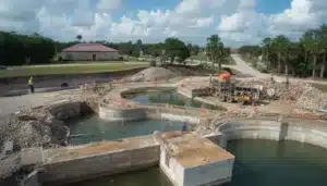 Construction of a Clay County, FL wastewater treatment system illustrating public utility improvements secured by a Water and Wastewater Maintenance Warranty Bond.