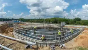 Workers maintaining a Clay County, FL water and wastewater treatment facility during the warranty period protected by a Water and Wastewater Maintenance Warranty Bond.