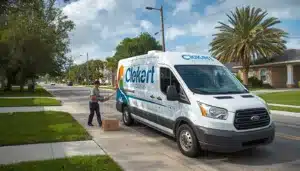 Florida private courier delivery van loading packages for residential deliveries, highlighting bonded courier operations in Broward County.