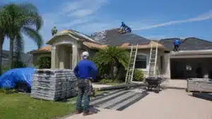 Florida roofing contractor overseeing residential roof replacement with new asphalt shingles