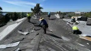 Florida roofing crew replacing residential shingle roof in a Florida waterfront neighborhood