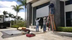 Florida contractor installing a non-electrical monument sign at a commercial entrance with precision alignment and structural support.