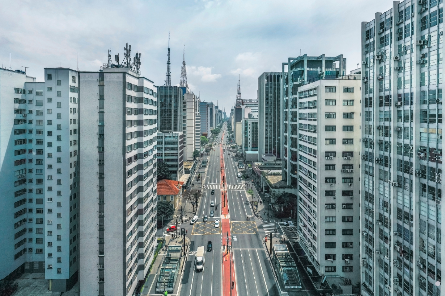 A long urban avenue surrounded by tall buildings and busy city infrastructure.