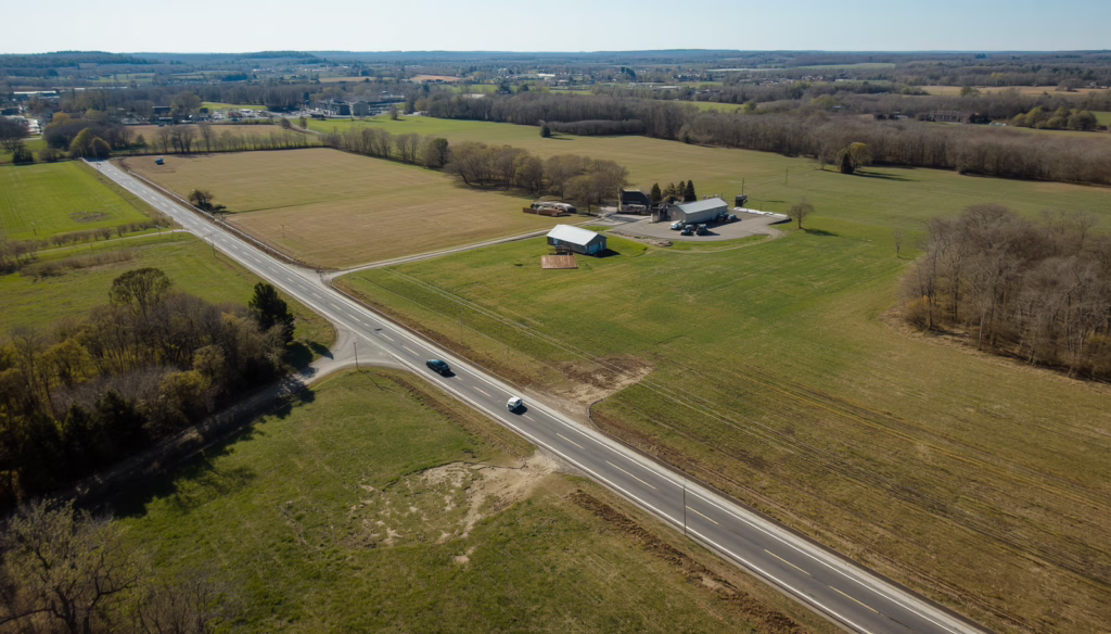 Open agricultural field in Connecticut representing land lease agreements that provide financial security and property use rights for tenants and owners.