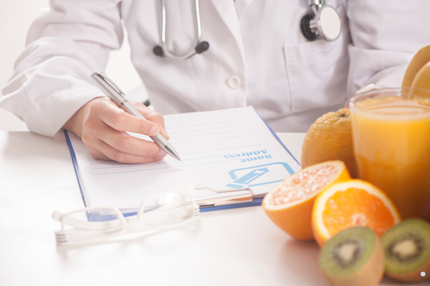 Medical professional completing paperwork beside food items, illustrating health compliance documentation and public health standards.