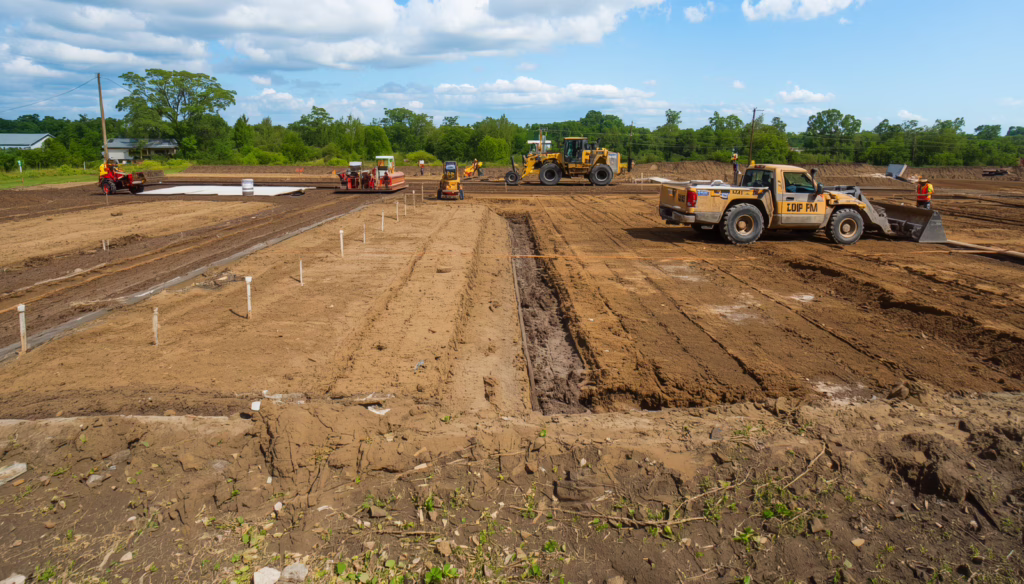 SEO alt text for Oakland, CA grading and erosion control construction site with heavy equipment performing land grading and soil stabilization work