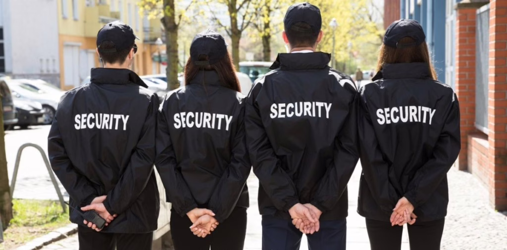 Security guard team standing in formation on city street representing agency staffing and patrol services.