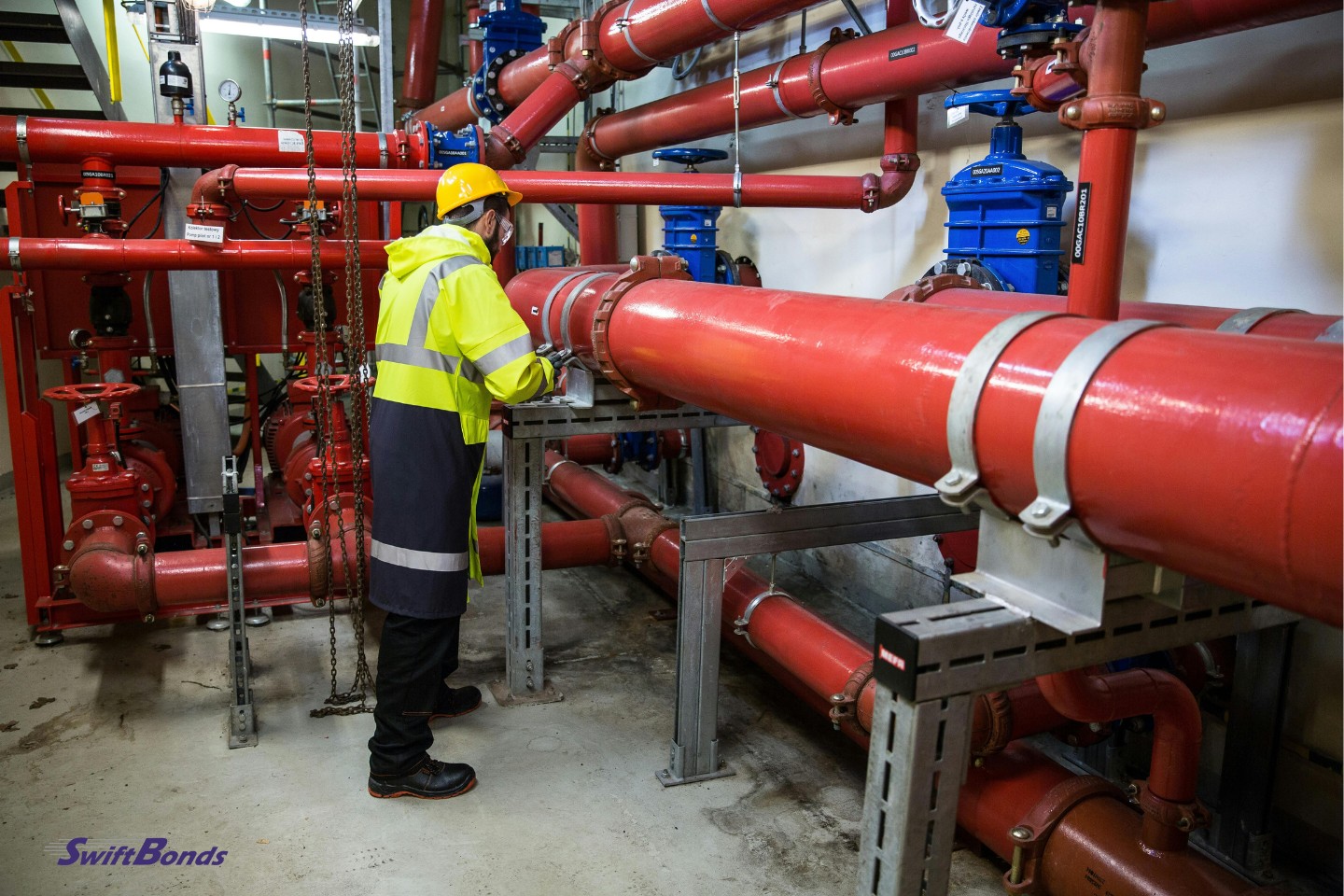 A contractor in a water system's pipeline room.
