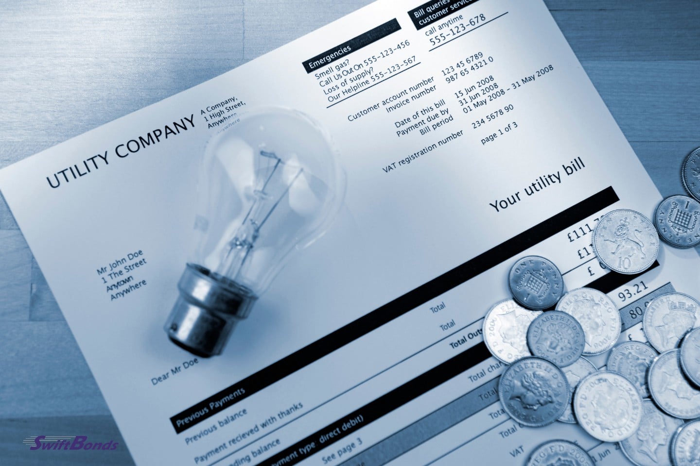 An image of a utility bill with coins and a lightbulb tinted blue.