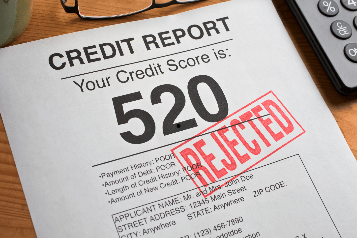 Credit report showing a low score of 520 marked with a red “Rejected” stamp.
