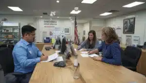 Motor vehicle title specialists assisting customers with bonded title paperwork under the New Hampshire Defective Title Bond process.
