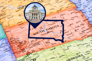 Map of South Dakota with a focus on the state's Capitol, emphasizing the importance of license and permit bonds for businesses operating within the state