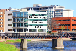 A modern building in South Dakota with a sign reading 'Types of License and Permit Bonds,' highlighting the variety of bonds required for different industries in the state.