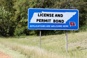 Roadside sign in Tennessee promoting license and permit bond applications for businesses seeking compliance.