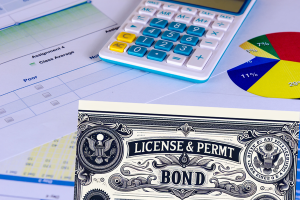 License and permit bond certificate alongside financial calculations and data charts, emphasizing the cost to get bonded and insured in Tennessee.