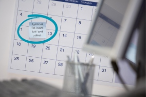 A calendar with a date circled for 'Application for License and Bond Permit,' emphasizing the importance of meeting deadlines and timelines for business licensing in Vermont's regulatory framework.