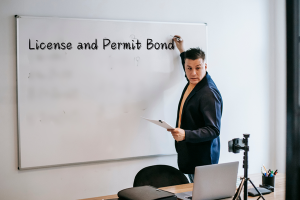 Business professional explaining the concept of license and permit bonds on a whiteboard, highlighting compliance requirements for Mississippi businesses.