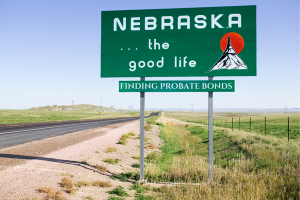 Nebraska road sign reading 'Nebraska...the good life,' with additional text 'Finding Probate Bonds,' symbolizing the search for estate bonds in Nebraska.