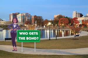 A woman standing next to a sign that reads 'Who Gets the Bond?' in a park setting.