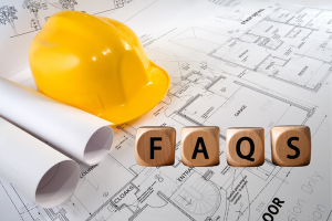 Close-up of a construction site plan with a yellow hard hat, rolled blueprints, and wooden blocks spelling 'FAQs,' emphasizing the importance of frequently asked questions for performance bonds in Mesa, Arizona.