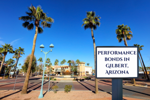 Downtown Gilbert, Arizona with palm trees and a street sign reading 'Performance Bonds in Gilbert, Arizona.' A sunny day highlights the clean streets and community atmosphere.