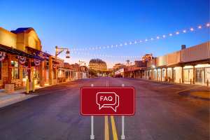 Street view in Old Town Scottsdale with an FAQ sign. Scenic downtown street in Old Town Scottsdale, Arizona, during the evening with a red FAQ sign in the middle of the road, highlighting frequently asked questions about performance bonds.