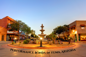 Downtown Yuma, Arizona at sunset featuring a central fountain surrounded by local shops and palm trees, highlighting the topic of Performance Bonds in Yuma, Arizona.