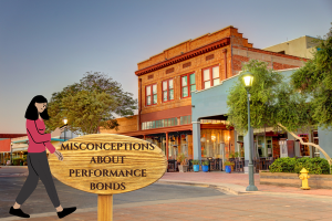 A woman walks near historic buildings in Yuma, Arizona, approaching a wooden sign reading 'Misconceptions About Performance Bonds,' emphasizing common misunderstandings.