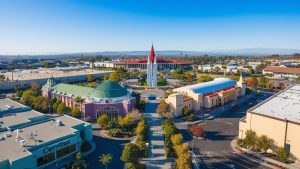 Aerial view of the Cerritos city center in California, showcasing iconic architecture, landscaped areas, and surrounding commercial buildings.