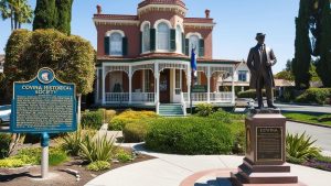 Covina Historical Society building in Covina, California, with a Victorian architectural style, manicured gardens, and a historical marker in the foreground.