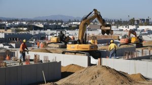 Construction site in Diamond Bar, California featuring heavy machinery and workers in safety gear, showcasing active project development supported by performance bonds.