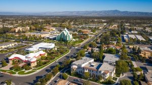 Aerial view of La Mesa, California, highlighting local architecture, palm trees, and the surrounding scenic landscape.