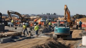 Busy construction site in Lodi, California, featuring workers, heavy machinery, and equipment actively building a project.