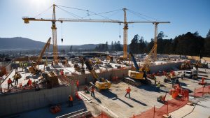 Active construction site in Mountain View, California, with cranes and workers, highlighting the importance of performance bonds for large-scale infrastructure projects.