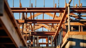 Close-up view of wooden and steel framing during the construction of a commercial building in Pleasanton, California, showcasing structural precision.