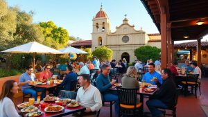 Vibrant outdoor dining scene in San Luis Obispo, California, with diners enjoying meals near a historic mission-style building.