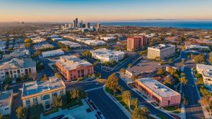 Aerial view of Cypress, California, featuring modern architecture, green spaces, and urban development, highlighting the city's growth and need for reliable construction practices backed by performance bonds.