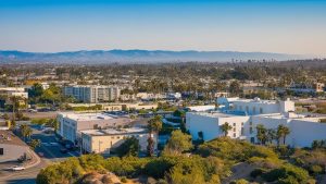 Downtown Hawthorne, California at sunset, featuring prominent office buildings and landmarks, ideal for illustrating business and contractor development related to performance bonds.