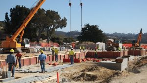 Active construction project in Rancho Palos Verdes, California, showcasing workers, heavy equipment, and a landscaped setting.