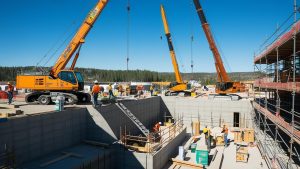 Construction site in Idaho Falls, Idaho, featuring cranes and workers assembling a modern infrastructure project.