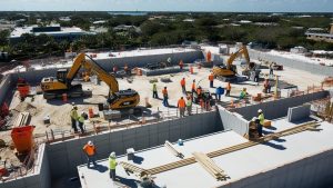 Construction workers and heavy machinery at an active building site in Wellington, Florida, demonstrating the importance of performance bonds in construction contracts.